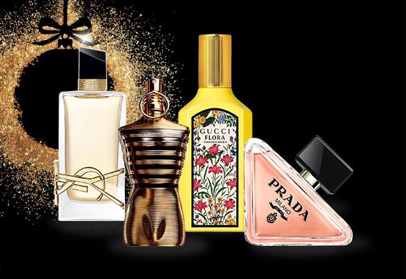 YSL, Hugo Boss, Rabanne and Prada products beside a gold glittery bauble on a black background
